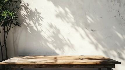 Empty wooden table with tree shadow on white wall background. Concept of natural, backdrop, display, and product placement.