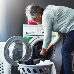 Laundry, machine and woman and cleaning at house for washing clothes, hygiene and fabric care for service results. Mature, female person and chores, cleaner and appliance for maintenance at home