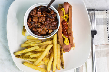 hot dog top  with  mustard and ketchup with chili