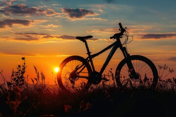 Naklejka premium Silhouette of a bike on sky background on sunset