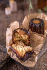 Portion of canele dessert on wooden background