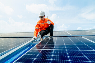 engineer man inspects construction of solar cell panel or photovoltaic cell by electronic device. Industrial Renewable energy of green power. factory worker working on tower roof.