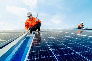 engineer man inspects construction of solar cell panel or photovoltaic cell by electronic device....