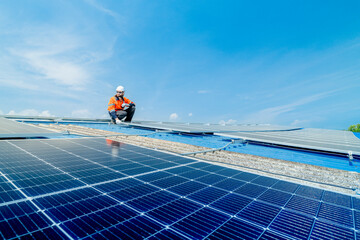 engineer man inspects construction of solar cell panel or photovoltaic cell by electronic device....