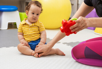 Child physiotherapy. Little boy receives physical therapy from a specialist
