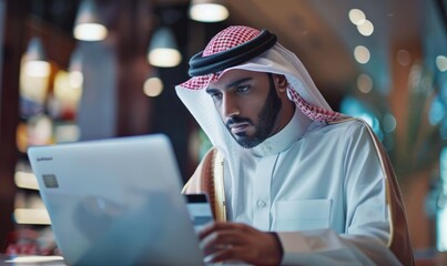 Saudi man is studying on a laptop