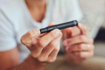 Diabetes, lancet pen and hands of person for blood sugar, monitor insulin and glucometer test. Healthcare, medical and finger with needle for glucose, diabetic treatment and hypoglycemia in home