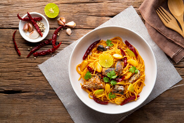 Spaghetti with Canned Mackerel and Dried Chili garlic in white plate.Fusion food.Top view