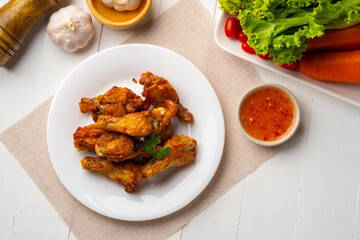 Air Fryer drummet chicken wing with Fish Sauce on white plate,less oil frying and crispy.Top view