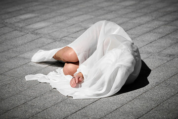 Female performer covered in white silk scarf waving gracefully, female outdoor dance performance on...