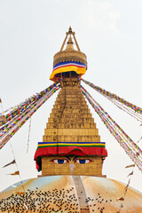 Boudhanath stupa in Kathmandu, Nepal decorated Buddha wisdom eyes and prayer flags, most popular tourist attractions in Kathmandu reflecting harmonious blend of spirituality and tourism