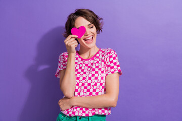 Photo portrait of attractive young woman heart cover eye laughing wear trendy pink clothes isolated on purple color background