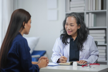 Doctor consulting with patient in a medical office, discussing health and wellness. Professional healthcare and medical advice concept.