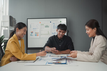 Asian business people team working on project in office and having fun