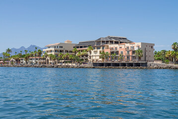 View of the boardwalk and architecture of the magical town of Loreto from the bay in the Sea of ​​Cortes, Baja California Sur. Mexico, summer vacation.