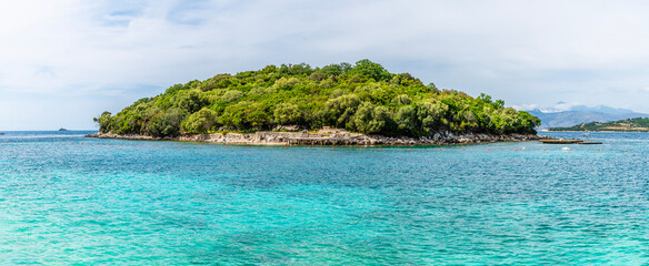 Naklejka premium A close up view towards an island offshore from the beach at Ksamil, Albania in summertime