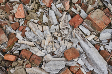 Pile of broken bricks and slate. Rubbish on a construction site. Waste after demolition of an old brick building