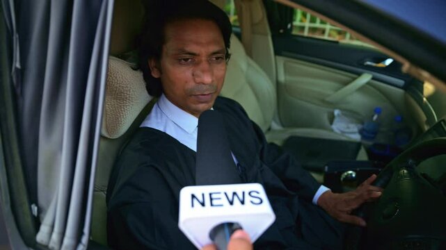 Solicitor sitting in vehicle gives interview