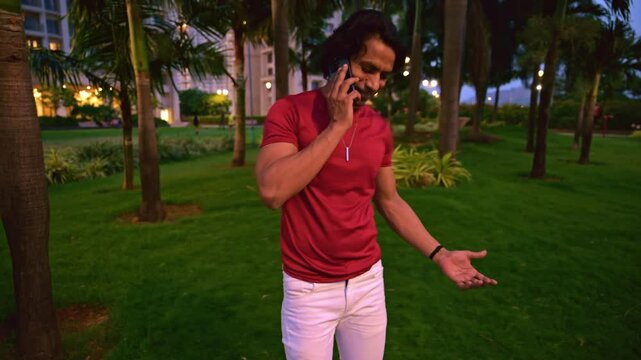 Man talking on smart phone in a park