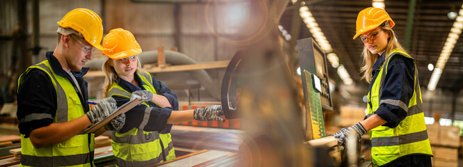 workers carpenter wearing safety uniform and hard hat working and checking the quality of wooden...