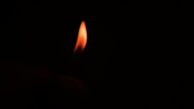 Orange fire in the dark in blur, bluer. Burning flame on blurred background.