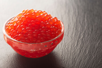 red caviar in a glass bowl is tasty and healthy