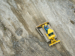 Aerial view of bulldozer working in mine. Heavy machinery for earth moving. © Mario