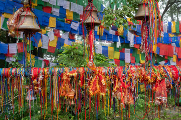 Hindu religious threads with wishes of devotees and Buddhist religious flags at Mahakal Temple, an amalgamation of Hindu and Buddhist religions coexisting peacefully. Darjeeling,West Bengal,India.