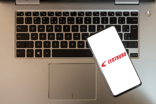 cell phone with the Centauro logo on top of the notebook