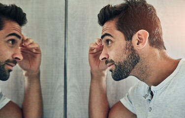Bathroom, eyebrow and man in mirror with tweezers for grooming, skincare and hair removal. Beauty,...
