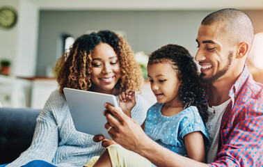 Tablet, happy family and kid with parents in home together for learning, education or relax. Girl, mom and father on digital technology to watch movie, cartoon or streaming video on living room sofa