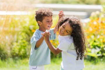 Obraz premium small mulatto children a boy and a girl on a summer walk
