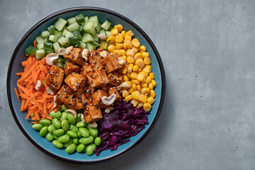 Healthy buddha bowl with falafel and vegetables on plate. 