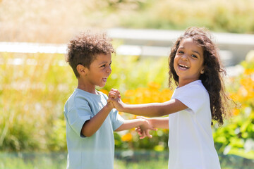 Fototapeta premium small mulatto children a boy and a girl on a summer walk