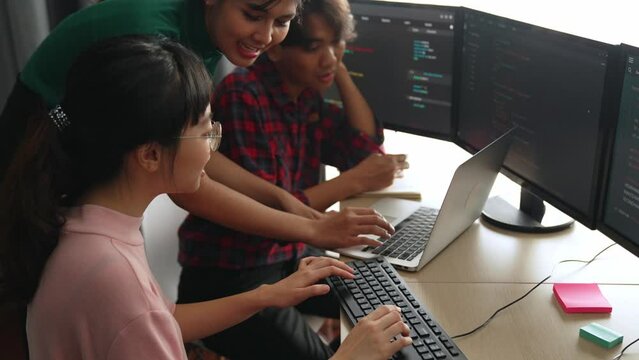 Back end software developer engineer for computer programming working together on debugging writing computing code, solving complex algorithms display on monitor in office. Burgeoning