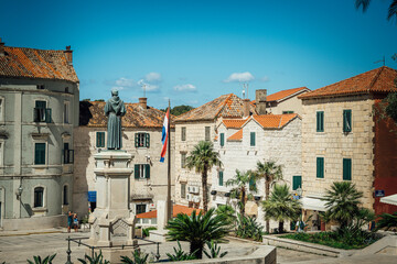 Beautiful view of the old buildings and a statue in the city Makarska in Croatia while traveling in Europe.