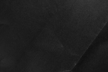 Black paper textured surface with a subtle fold and unique natural pattern. Dark cardboard tones
