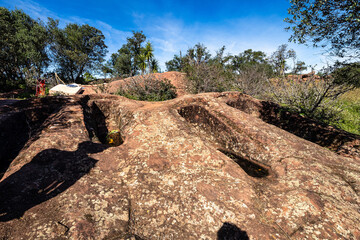 Granite rock cut anthropomorphic grave in Vale Fuzeiros at Vilarinha, Algarve, Portugal.