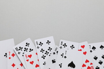 Playing cards on gray background, top view. Gambling concept