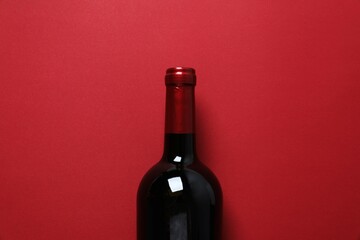 Bottle of red wine on color backgroun