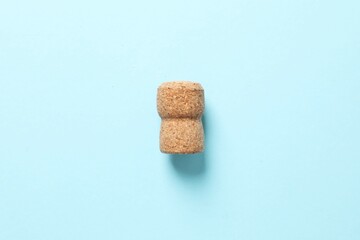 Cork of champagne on colored background