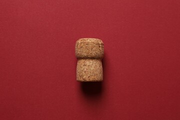 Cork of champagne on colored background
