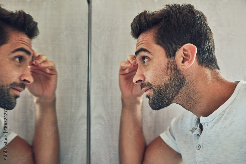 Poster Home, eyebrow and man in mirror in bathroom for grooming, skincare and dermatology. Beauty, cosmetics and person check face for wellness, facial treatment and health for hygiene in morning routine