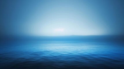 A serene blue ocean with a hazy sky and gentle waves.