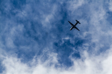 Single plane performs a stunning show at an air show, against cloudy blu esky.