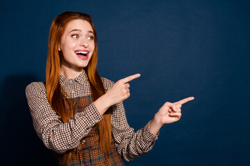 Fototapeta premium Photo of excited impressed lady lady dressed plaid outfit showing two fingers looking empty space isolated dark blue color background