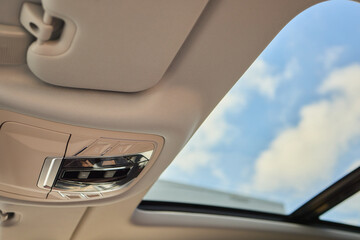 Motor vehicle with sunroof, rear view mirror, and hood