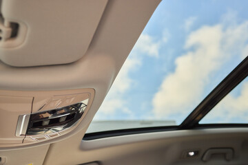 Motor vehicle with sunroof, rear view mirror, and hood