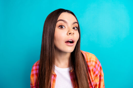 Portrait of nice girl listen attentive wear checkered shirt isolated on turquoise color background