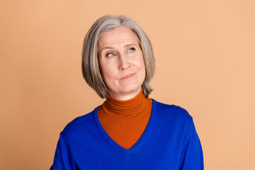 Photo portrait of lovely pensioner lady look skeptical empty space dressed stylish blue garment...